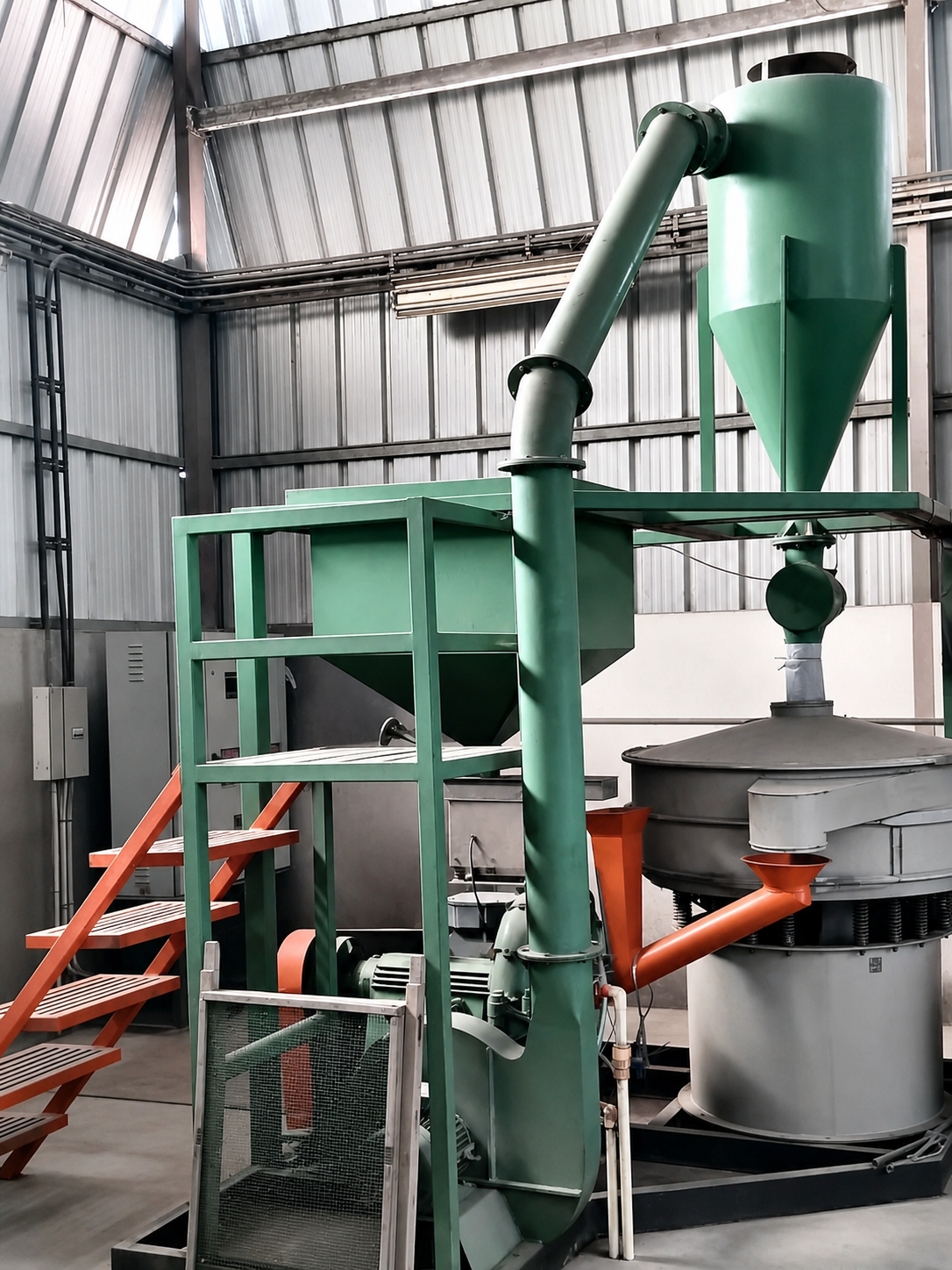 Green material-processing equipment and cyclone system inside the Roto Polymers facility.
