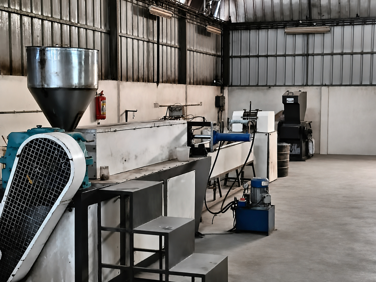 Production line and industrial processing equipment inside the Roto Polymers facility.